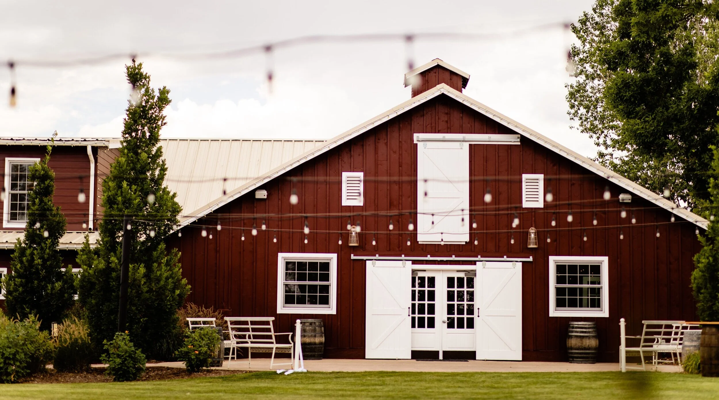 The Barn at Raccoon Creek — wedding venue with string lights on the Grant Ranch property